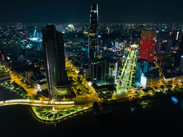 Night Drone Photo of Nguyen Hue Walking Street next to Bitexco Financial Tower and Saigon One Tower in District 1 in Ho Chi Minh City, Vietnam