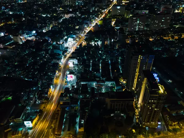Night Drone Photo with Traffic Light Streaks with many Buiildings and Houses from above in District 1 in Ho Chi Minh City, Vietnam