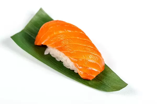 Nigiri with fillet salmon on a green leaf