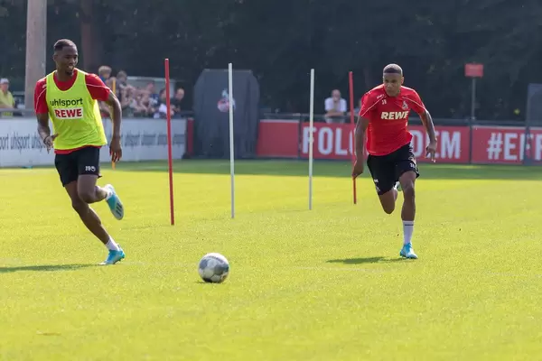 Nikolas Terkelsen Nartey - defensive midfield - and football player Kingsley Ehizibue outside on the field at 1. FC Köln training center