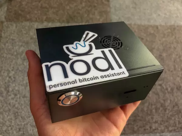 Nodl Personal Bitcoin Assistent Device in a mans hand