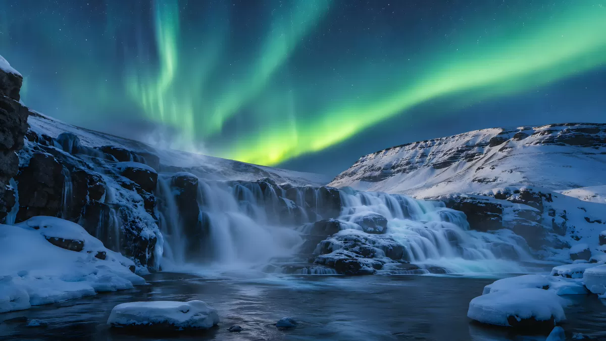 Nordlichter über gefrorenem Wasserfall in Island