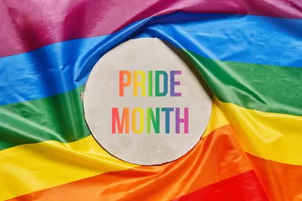 Note Pride month over a rainbow lgtbt flag