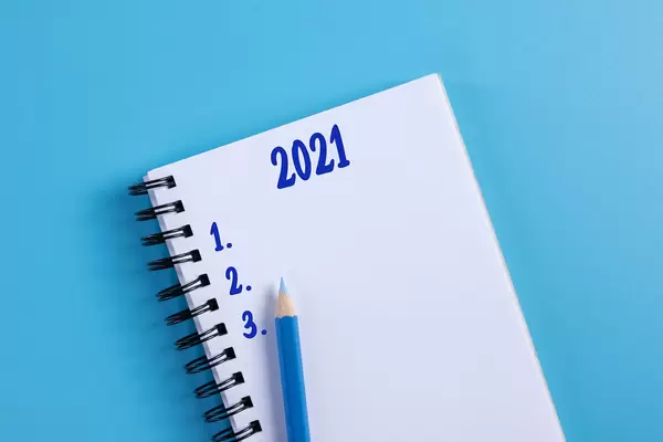Notebook with 2021 List to do on blue background
