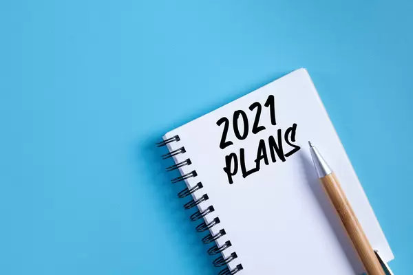 Notebook with 2021 Plans text on blue background