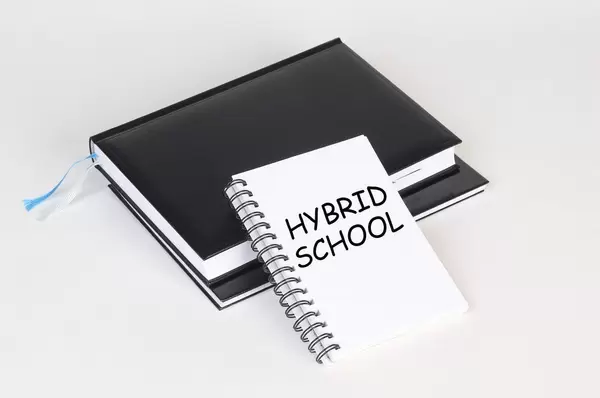Notebook with Hybrid School text