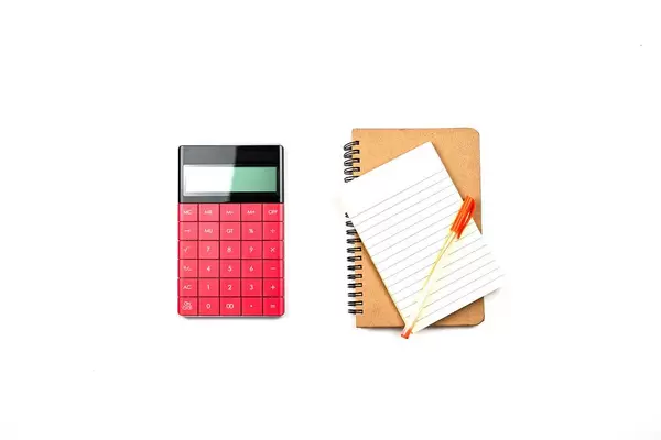 Notepad with pen and calculator on the table