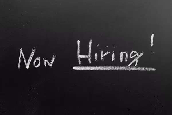 Now Hiring! with chalk on a blackboard hand-written