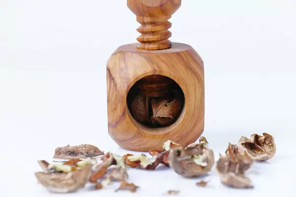 Nutcracker near walnuts and nutshell