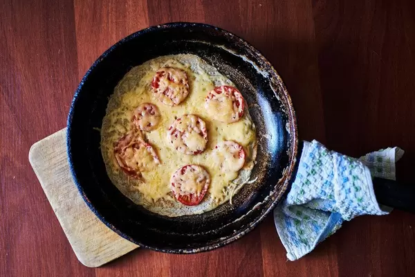 Nutritious breakfast. Healthy Shakshuka (pan baked eggs and tomatoes) (Flip 2020)