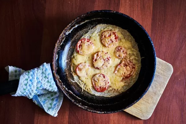 Nutritious breakfast. Healthy Shakshuka (pan baked eggs and tomatoes)