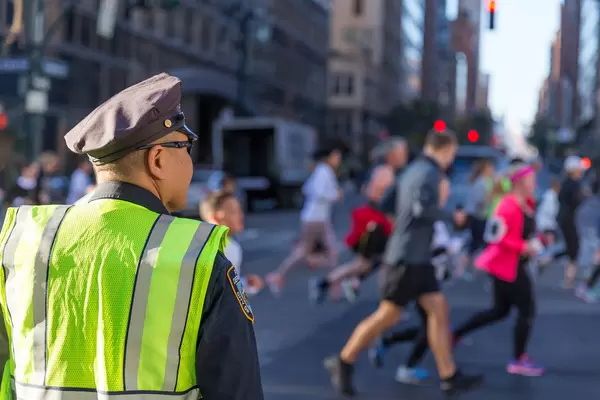 NYPD officer watching New York Marathon