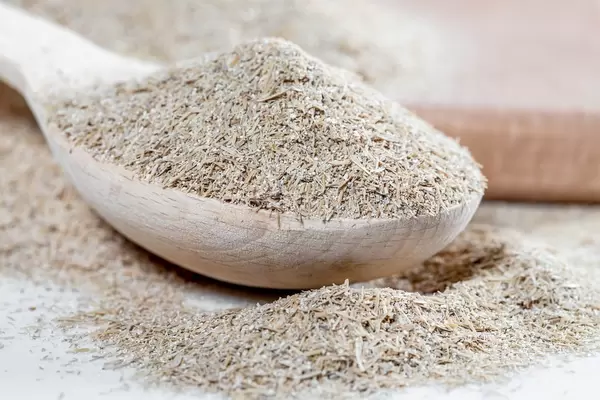 Oat bran in wooden spoon on kitchen board  Flip 2019