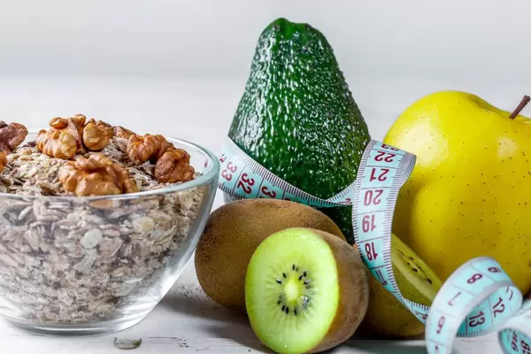 Oat flakes with fresh fruit and nuts and measuring tape