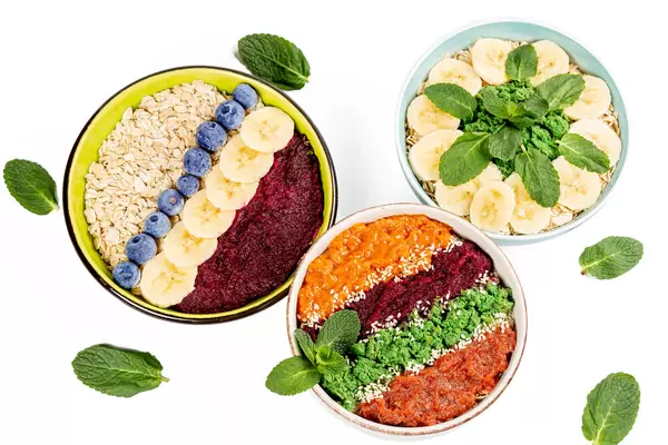 Oat flakes with fresh fruits, berries, mint and fruit purees, healthy food concept