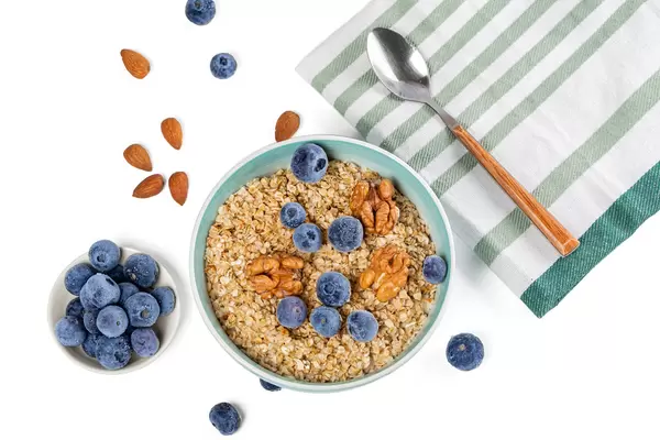 Oat flakes with nuts and blueberries, top view