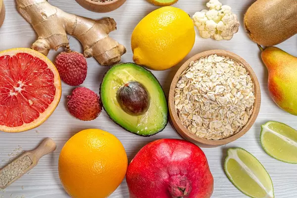 Oatmeal flakes with colorful fruits and ginger root. Concept ingredients for making a healthy Breakfast