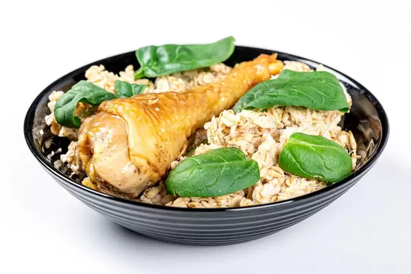 Oatmeal porridge with baked chicken leg