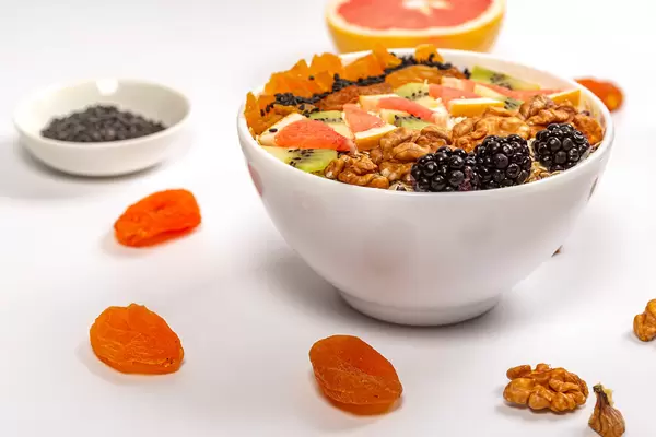 Oatmeal with blackberries, walnuts, grapefruit, kiwi and dried apricots