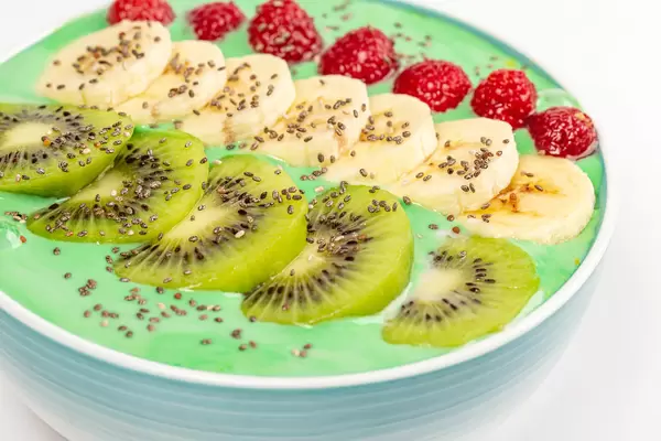 Oatmeal with chopped fresh banana, kiwi, raspberries, chia seeds and yogurt