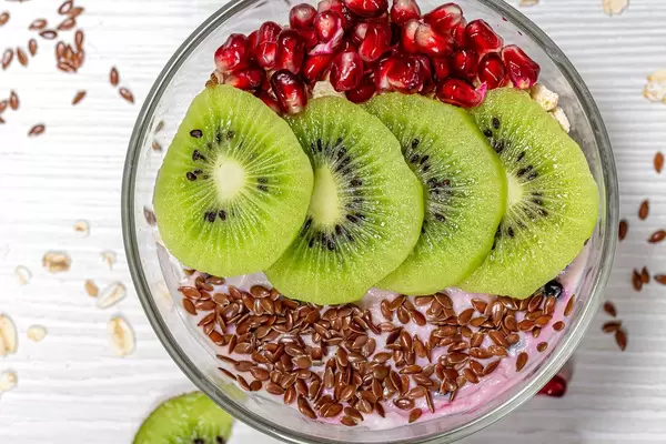 Oatmeal with flax seeds, kiwi slices and pomegranate. The concept of a healthy Breakfast. Top view