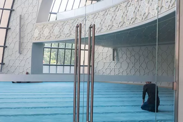 Observant Muslims during praying in the Mosque in Ehrenfeld, Cologne