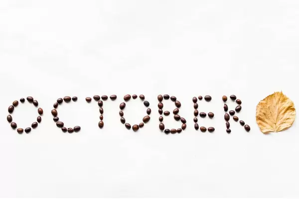 October written with coffee beans. Autumn composition