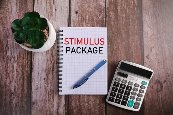 Office desk table with notebook, calculator and Stimulus Package text