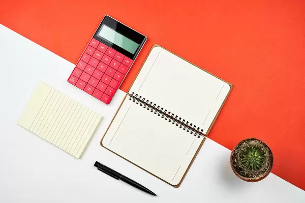 Office flat lay on split tones red and white background