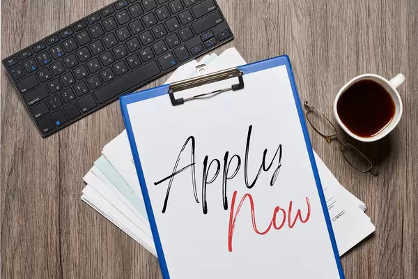 Office workspace - Apply now text on clipboard