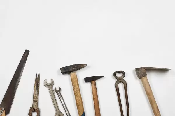 Old and rustic handy working tools on the white background