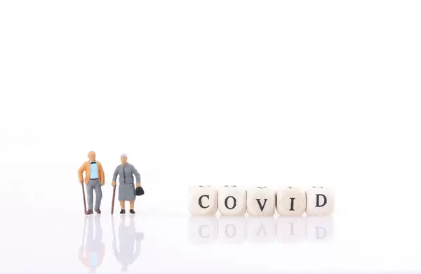 Old couple with Covid text on white background