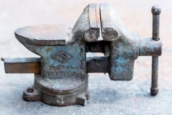 Old iron vise on white background
