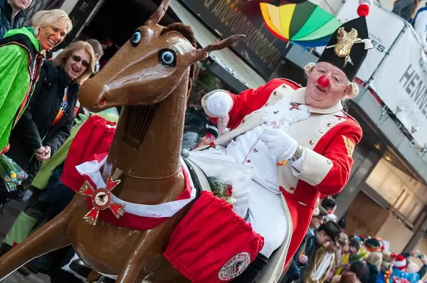 Old man rides a horse from plastic at carnival time