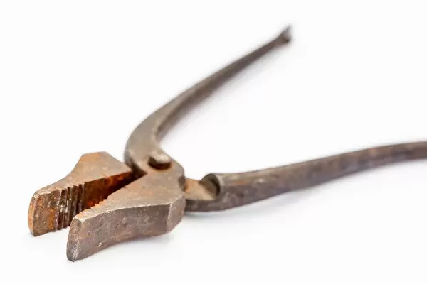 Old pliers on a white background For repairman.
