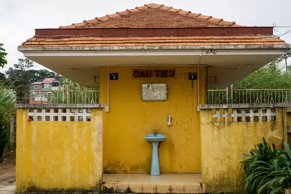 Old Yellow Toilet Building from French Colonial Time at the Dalat Railway Station in Da Lat, Vietnam