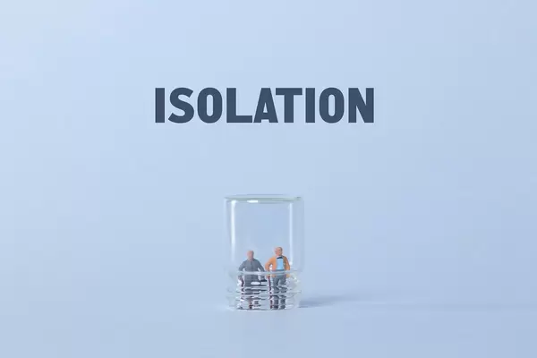 Older couple inside glass and Isolation text