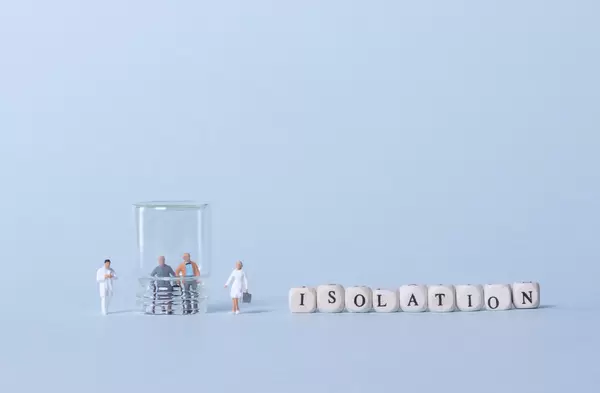 Older couple inside glass, two doctors and Isolation text