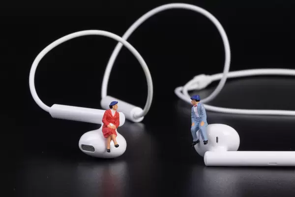 Older couple sitting on earbuds