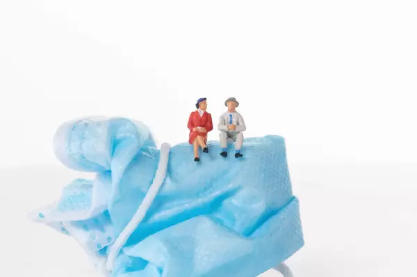 Older couple sitting on medical face mask