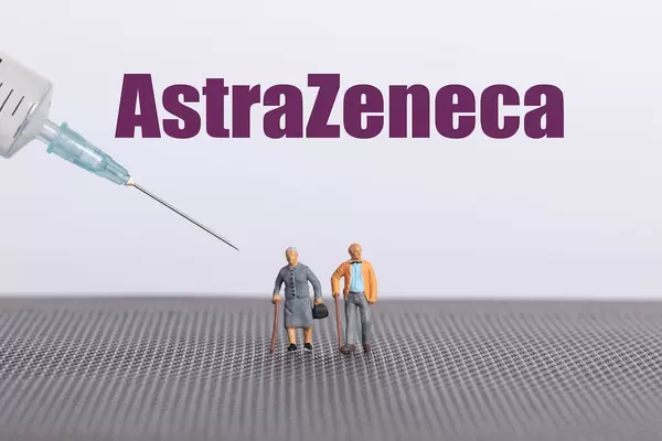 Older couple with syringe and AstraZeneca text