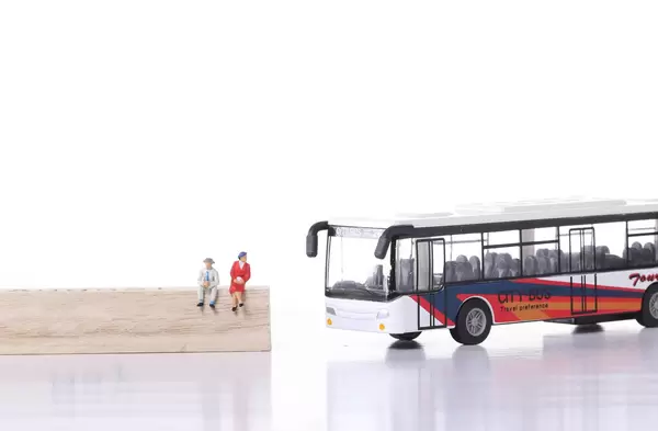 Older man and women with city bus