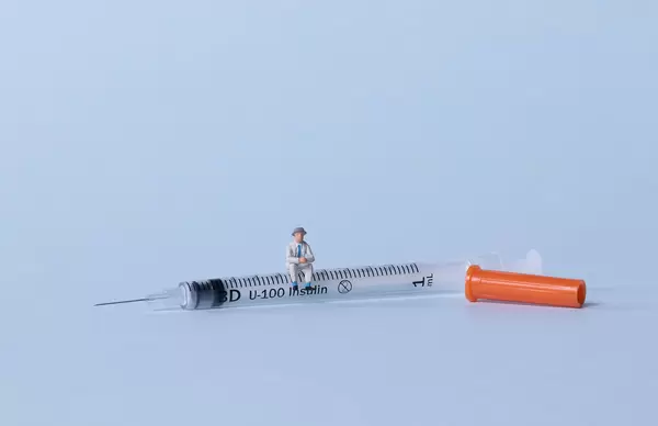 Older man sitting on a syringe