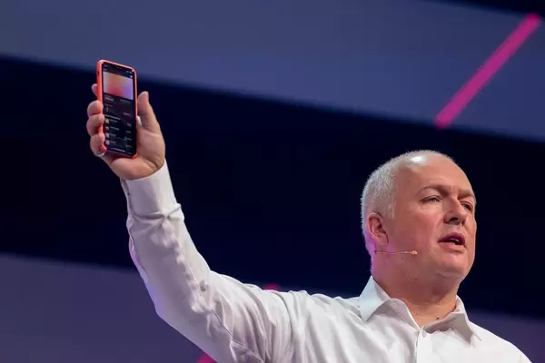Oliver Ratzesberger, CEO and President of leading data analytics corporation Teradata, holds an iPhone in the hand and shows transactions made with the Apple Card