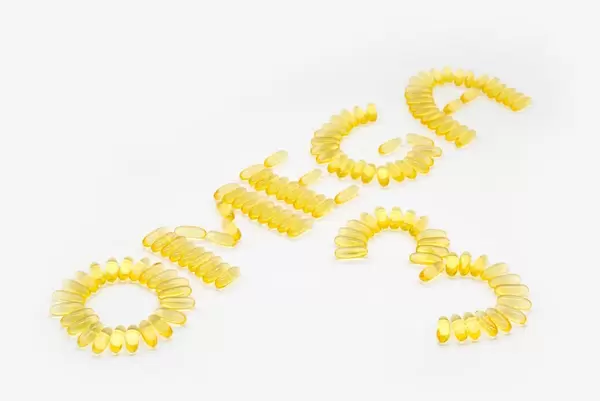 OMEGA 3 written with fish oil capsules containing fatty acids