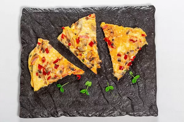Omelet slices with vegetables and mushrooms. Top view