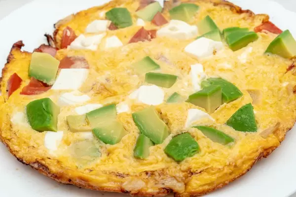Omelet with Avocado Cheese and Tomatoes on the plate