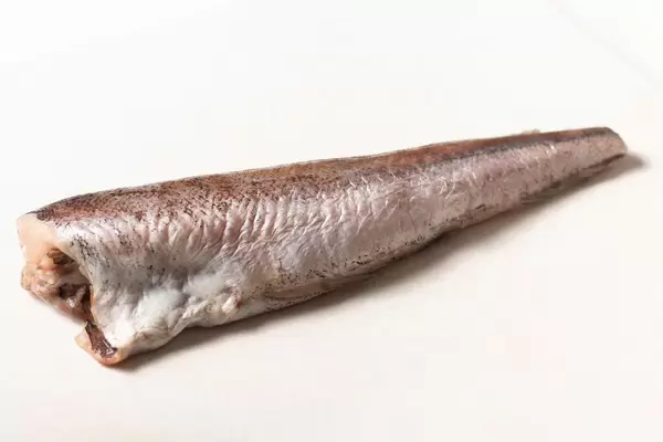 One Hake fish ready for frying, isolated above white background