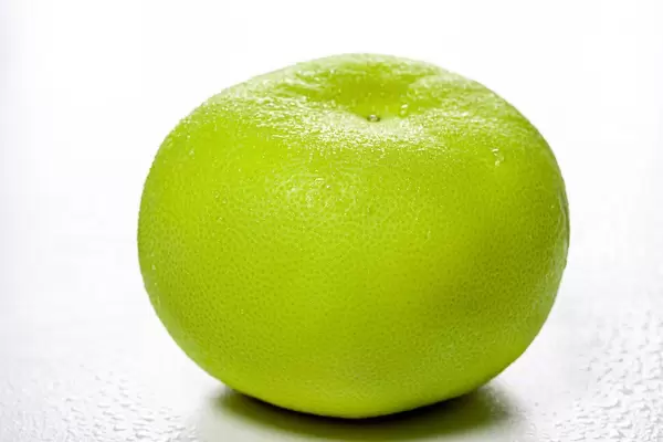 One whole Citrus Sweetie (Oroblanco ) on white background (Flip 2019)