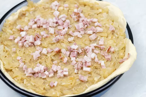 Onion Pie with sliced Bacon ready for baking